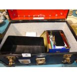 A small travel trunk and contents including four model vehicles and a box of curios
