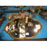 A gilt framed wall mirror, bell pull, brass animal ornaments, heraldic plaque, candle snuffers