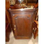 A Georgian oak corner wall cabinet with flat front