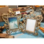 A pair of cast brass accanthus photo frames