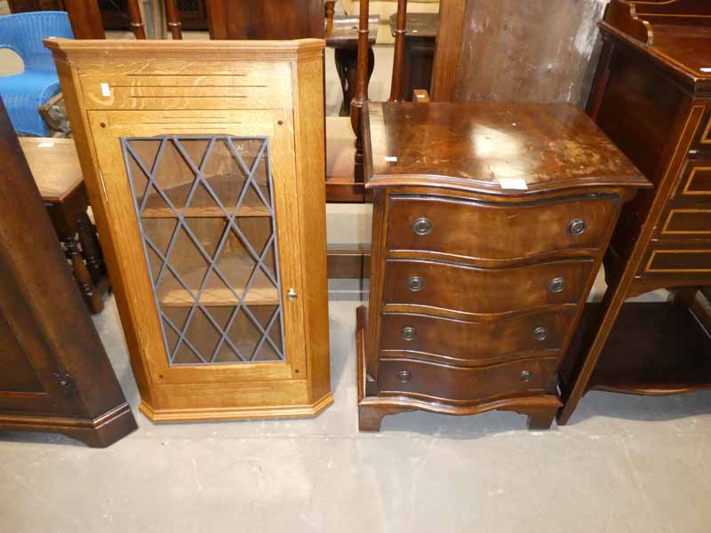 A small Serpentine front chest of four drawers and an oak corner wall cabinet