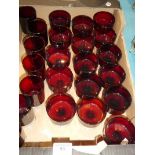 A set of sixteen ruby glass sundae dishes and a set of seven similar wine glasses