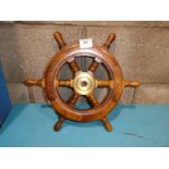 A small ships wheel, teak with six spokes