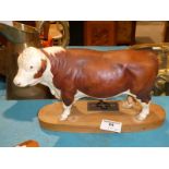 A Beswick large matt pulled Hereford Bull on wooden plinth