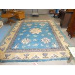 A large Chinese wool rug, lapiz and tan ground with typical devices, knotted ends