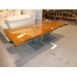 A 1970s designed waney edged coffee table on grey slate twin pillar supports, 150 cm L