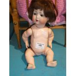 A German bisque head doll with BP mark in a heart