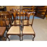 A set of four Edwardian inlaid chairs with drop-in pads