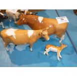 A Beswick Guernsey Family - calf damaged