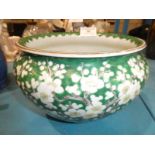 A mid 20th century green ground Chinese porcelain planter in prunus to green ground