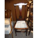 An Edwardian mahogany bedroom chair.