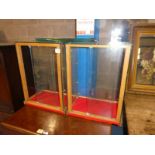 A pair of glass sided table top display cabinets