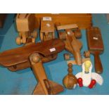A group of wooden toys including an elephant, racing car, bi-plane, tractor, two maracas and a