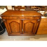 A reproduction two door sideboard with shelved interior