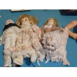 A group of four late 20th century bisque head dolls including one crawler, a Pierrot, plus two