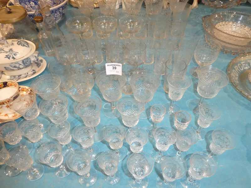 A large collection of etched drinking glassware