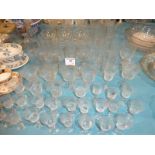 A large collection of etched drinking glassware