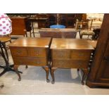 A pair of oak two drawer low bedside cabinets