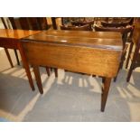 An oak drop leaf Pembroke table with frieze drawer on square taper legs