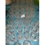 A large collection of etched drinking glassware