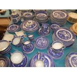 A large quantity of Alfred Meakin blue and white tableware in the Old Willow pattern