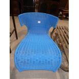 A blue plastic rattan lounger chair