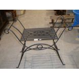 A wrought metal and strapwork window seat