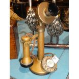 A brass candlestick telephone