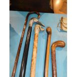Five walking sticks including dog and stork, head style, silver mounted cane etc