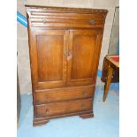 An oak shelved two door cabinet over two drawers