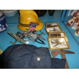 Firemans helmet, tunic, badge and axe, four small framed prints including Spitfire, wrist watch