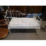 A Victorian wrought iron and brass child's cot with modern mattress 122cm