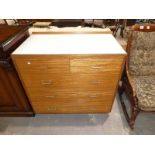 A mid-century formica top teak chest of two over three drawers