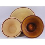 Two graduated Panchears or dough bowls in terracotta with cream glaze plus Wetheriggs Penrith