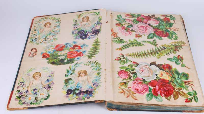 A Victorian scrapbook containing loose and fixed decoupage 30cm x 48cm