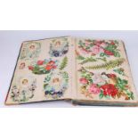 A Victorian scrapbook containing loose and fixed decoupage 30cm x 48cm