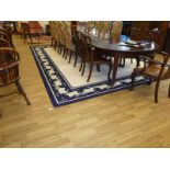 A large cream and blue lounge carpet in the cala lily pattern 345 cm x 445 cm