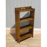 Arts & Crafts oak open bookshelf with pegged through tenons and pierced crest. 64cm x 19cm x 100cm