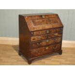 A George III Yew wood bureau, with classical cascade fitted interior over a two drawer base on