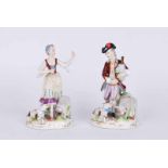 A pair of 19th century figure groups of a gentleman piper in tricorn and breeches, and a lady