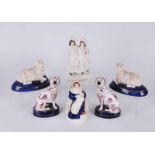 A group of Staffordshire figures to include a pair of sheep, a pair of purple lustre decorated