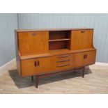 1960s/70s teak sideboard with drinks compartment and shelves with a sliding door, on a twin double