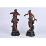 A pair of early 20th century patinated spelter figures of Improvisateur and Prisonniere by Ernest