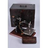 A boxed Willcox & Gibbs Sewing Machine Co, hand cranked sewing machine