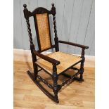 A 19th century caned back and rush seated rocking chair