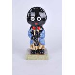 Carlton ware large golly figure playing clarinet. Black backstamp, marked Colour Trial . 20cm high