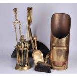 A set of Edwardian brass fireside companions in stand, together with dustpan and brush, toasting