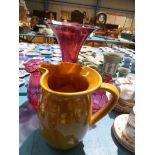 Cranberry trumpet vase and two further cranberry vases and mustard pottery ewer