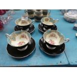 A set of 4 Shelley blackware cups and saucers, internally decorated