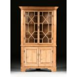 A GEORGE III STYLE WAXED PINE CORNER BOOKCASE CABINET, with a tapering molded cornice above an